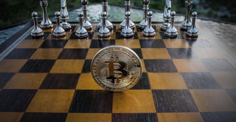 A shiny bitcoin coin on a chess desk