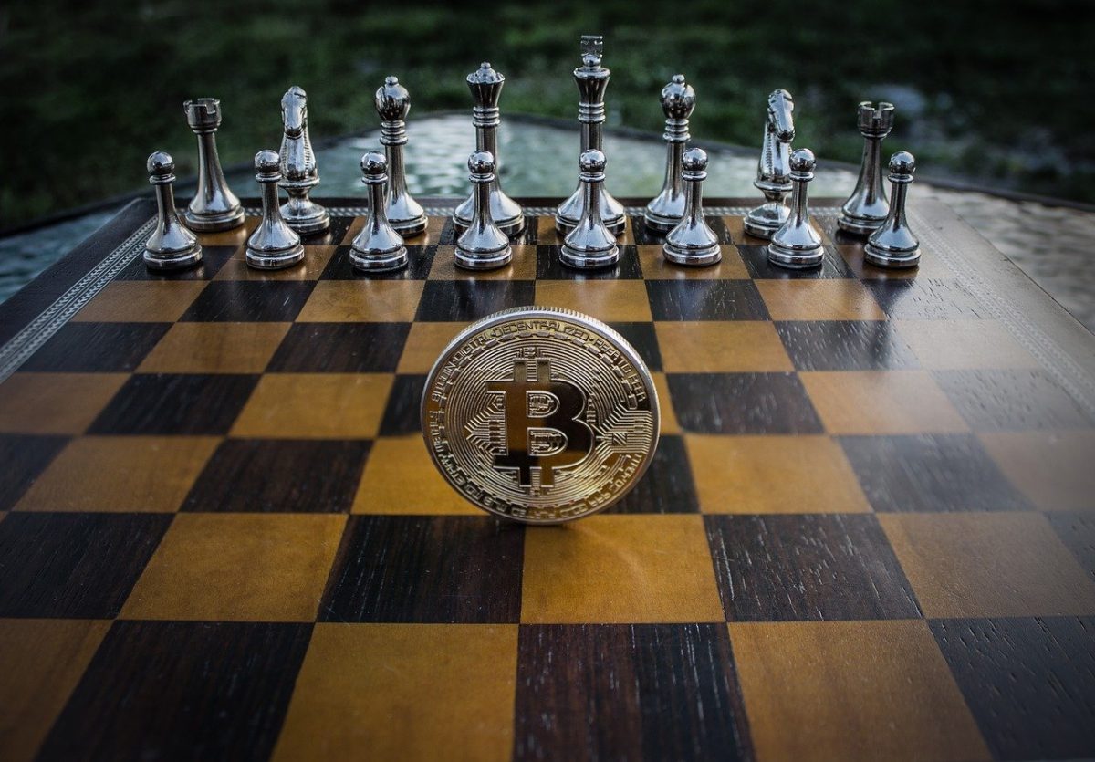 A shiny bitcoin coin on a chess desk