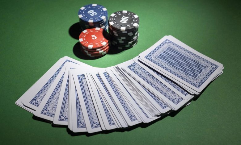 casino-tokens-on-green-background-with-deck-of-cards-free-photo