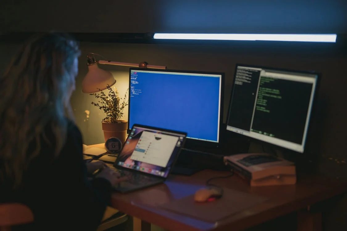 Women using desktop and laptop