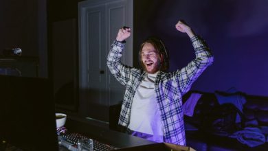 man-in-plaid-shirt-happily-playing-a-computer-video-game