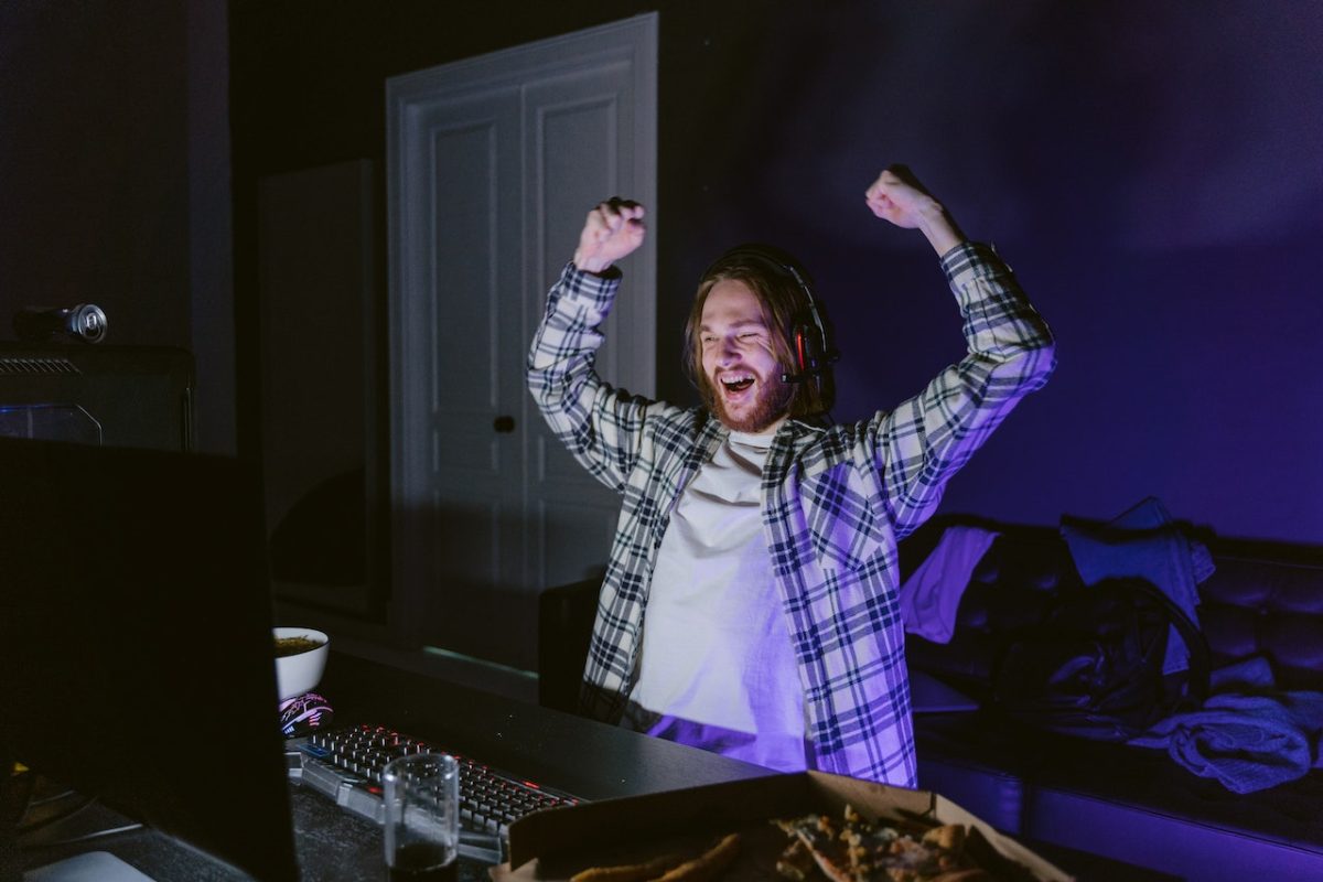 man-in-plaid-shirt-happily-playing-a-computer-video-game