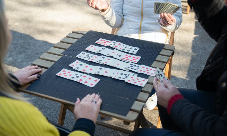 Group of People Playing Solitaire